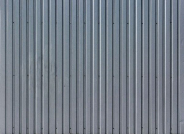 Fresh siding texture with lined pattern and nails in surface.