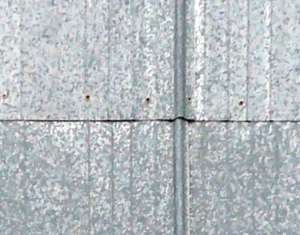 Aluminum sheet metal panels with shiny, grey surface and slightly rusted edges.