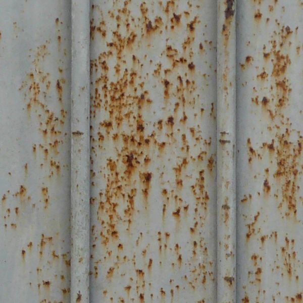 Metal siding with lined texture and very worn, rusting surface.