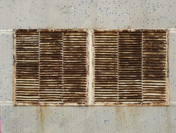 Metal vent texture with very worn surface and rust.