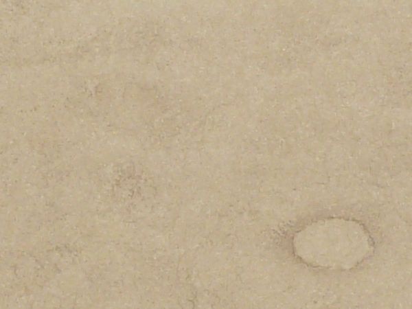 White paper texture with several large oval water marks and dark staining along the bottom edge.