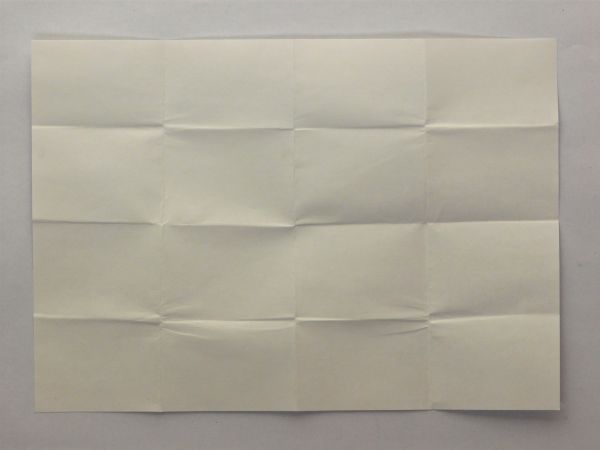 White paper texture with a pattern of rectangular folds covering its surface.