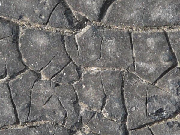 Plastic fabric with very dirty texture and random cracks in surface.
