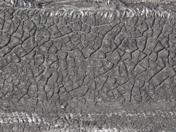 Plastic fabric with very dirty texture and random cracks in surface.