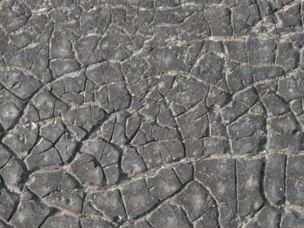 Plastic fabric with very dirty texture and random cracks in surface.