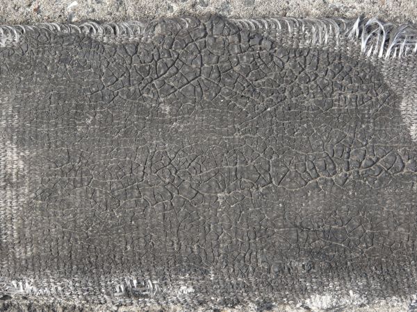 Plastic fabric with very dirty texture and random cracks in surface.
