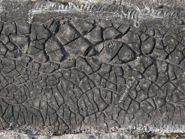 Plastic fabric with very dirty texture and random cracks in surface.