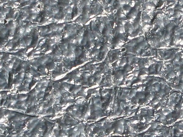 Plastic texture in shiny grey tone with very wrinkled surface.