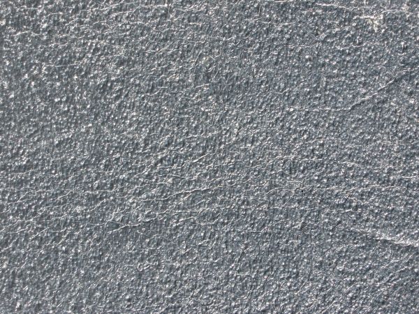 Plastic texture in shiny grey tone with very wrinkled surface.