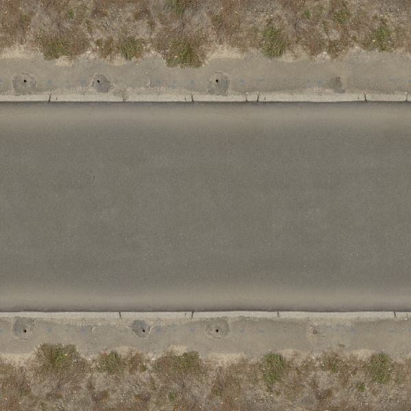 Seamless texture of asphalt road in dark grey tone with clean, smooth surface and rough edges.