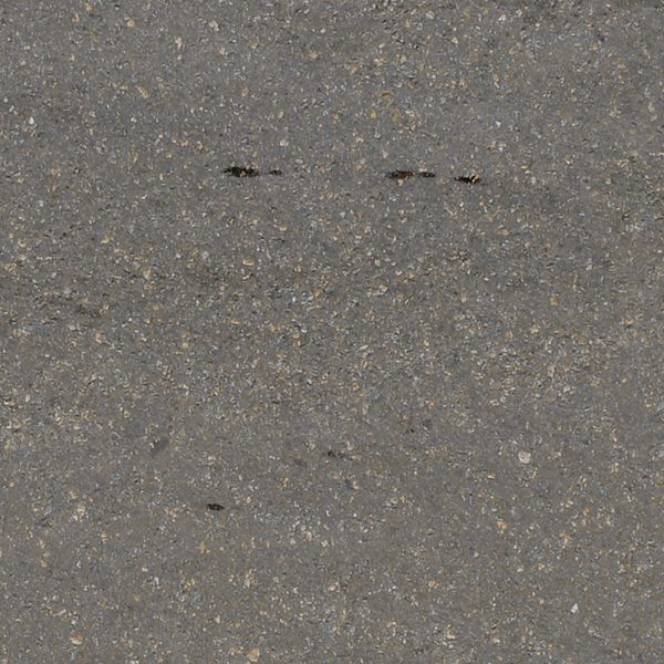 Texture of grey, asphalt road with clean surface and wet sand on edges.