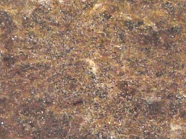 Flat cave rock texture in various tones of brown  and grey with slightly rough, scratched surface.