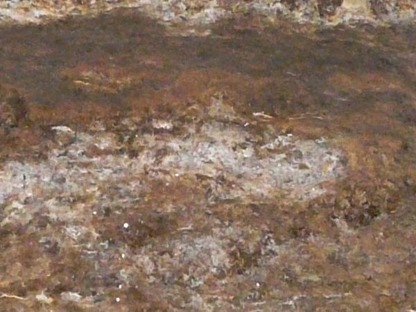 Flat rock texture in mixed colors consisting of multiple layers of various stone types.