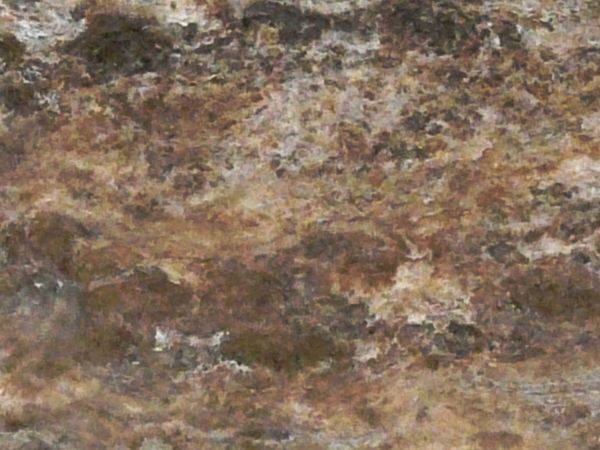 Flat rock texture in mixed colors consisting of multiple layers of various stone types.