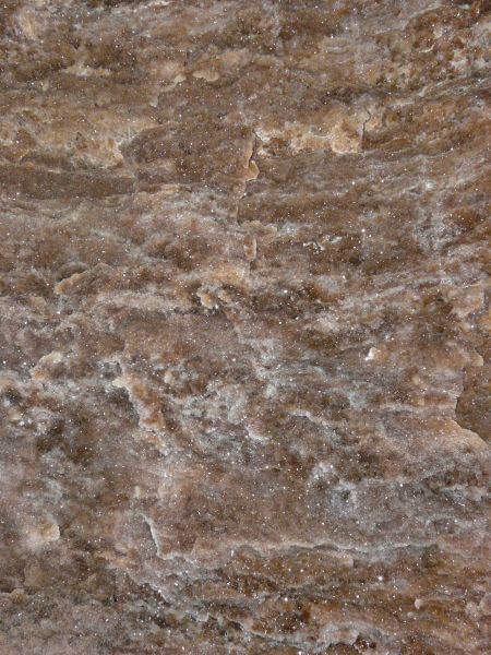 Texture of flat, quartz surface in brown and grey tones with slightly rough consistency.