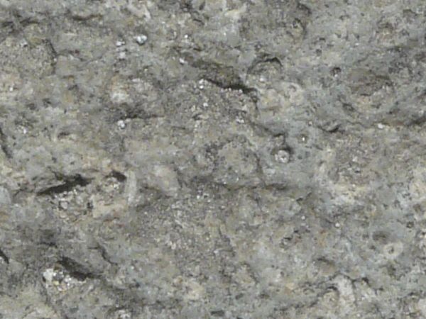 Rough stone texture in consistent, grey tone with very bumpy surface.