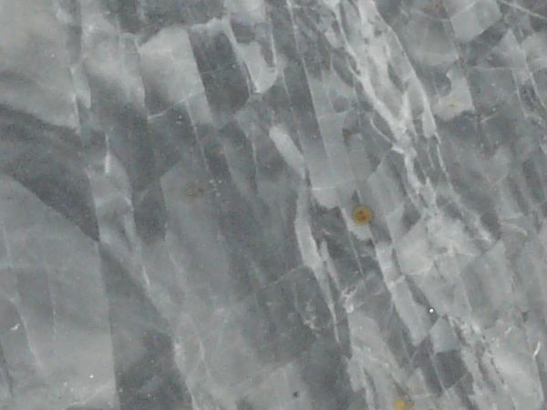 Smooth stone texture in grey and white tones with random patterns on surface.