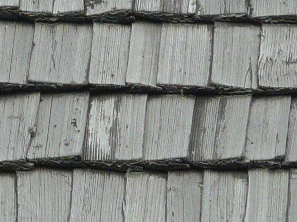 Roofing texture of grey, wooden planks with slightly worn surfaces.