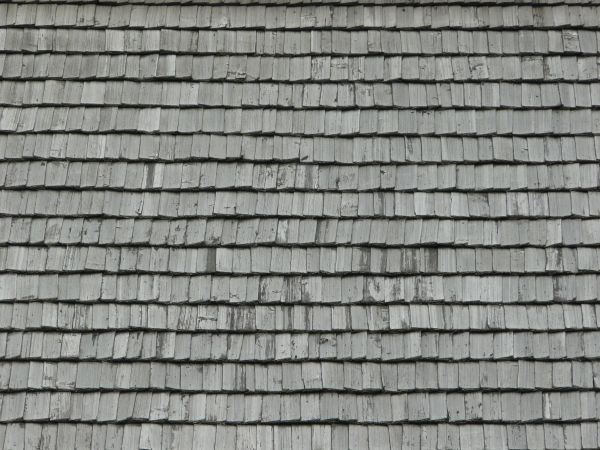 Roofing texture of grey, wooden planks with slightly worn surfaces.