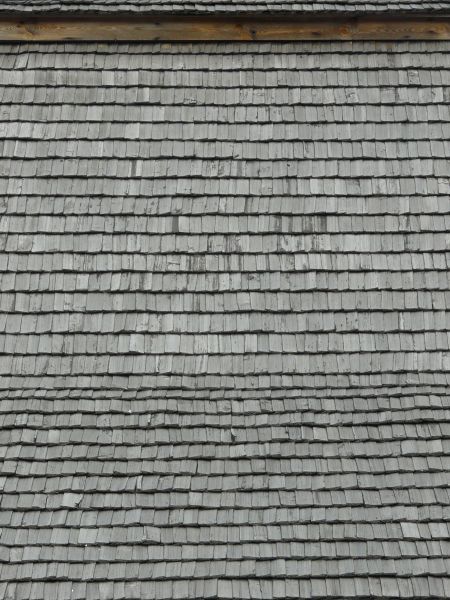 Roofing texture of grey, wooden planks with slightly worn surfaces.