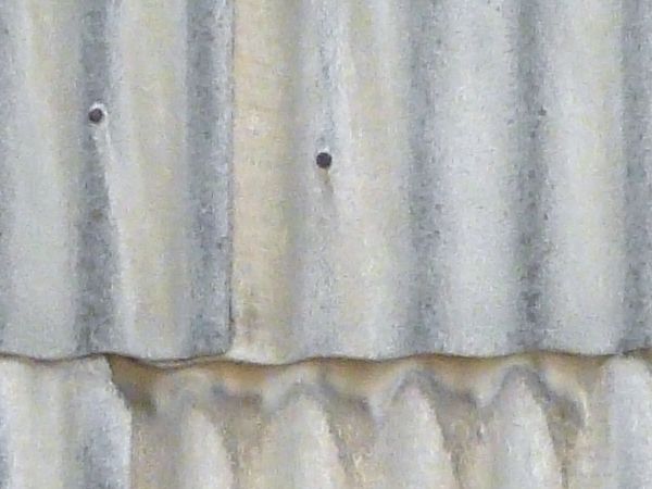 Roof texture consisting of silver sheet metal with wave-like surface.