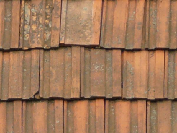 Seamless roof texture of flat red shingles with embedded line patterns.