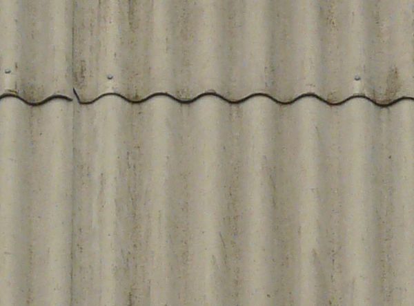 Roof of solid slates with wave-like, grey surface.