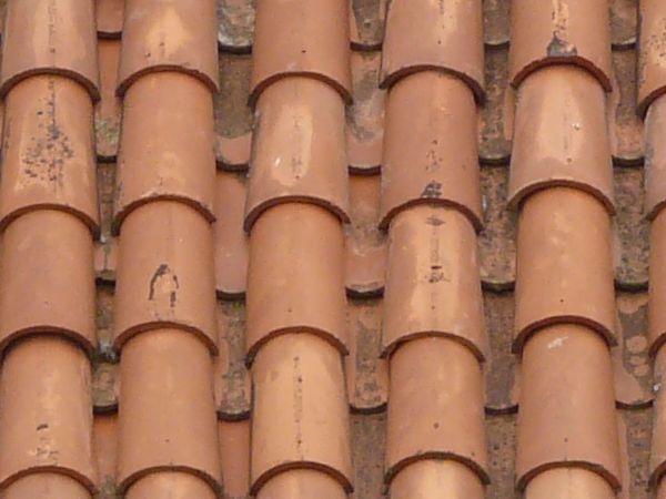 Roof texture of red shingles with curved shape.