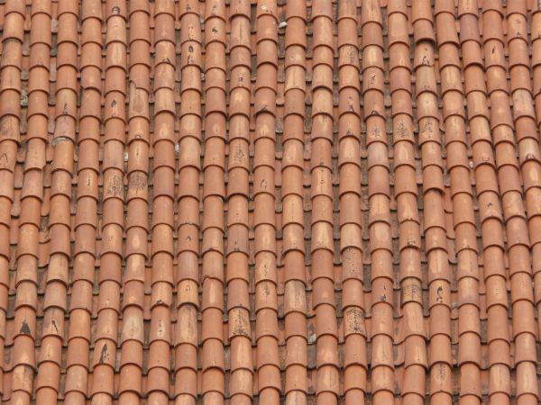 Roof texture of red shingles with curved shape.