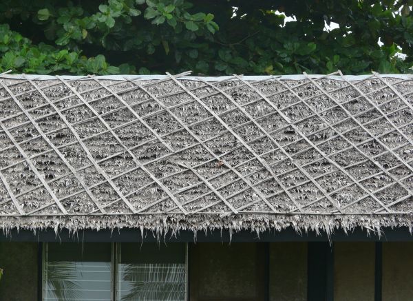 Roof texture consisting of dry grey grass with wooden planks in diamond pattern.