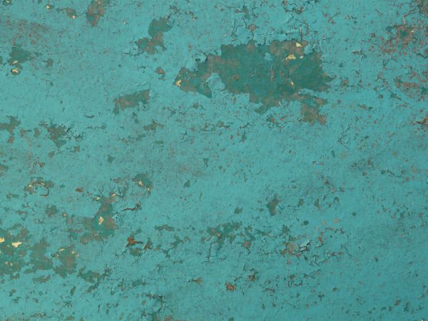 Blue painted metal texture, with extensive chipping, discoloration and faint brown rust stains.
