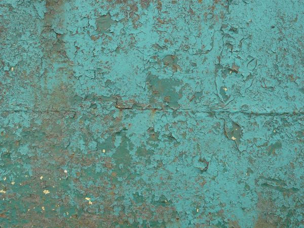 Blue painted metal texture, with extensive chipping, discoloration and faint brown rust stains.