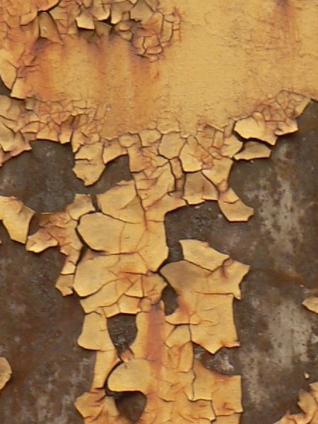 Red and white metal texture, with large chipping areas and completely covered by orange and brown rust stains.