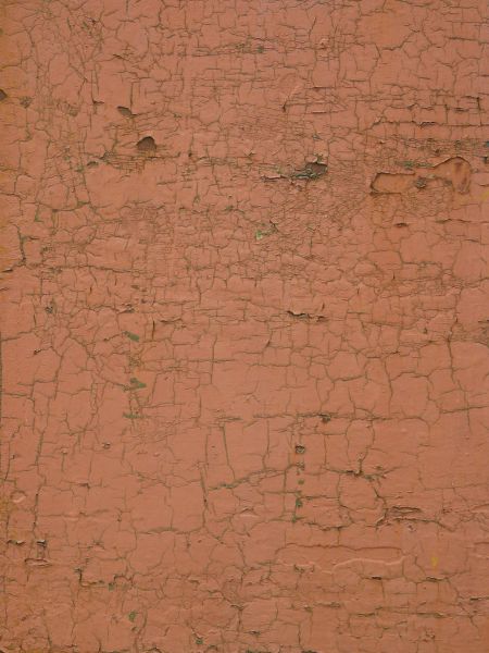 Chipping red paint texture, with rust stains faintly visible in the cracks.