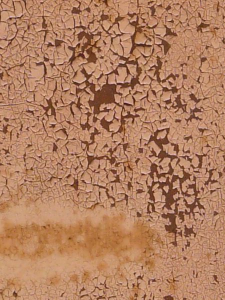 Pink painted metal texture, covered with many small cracks and discolorations, and with a dark red rusted surface visible underneath.