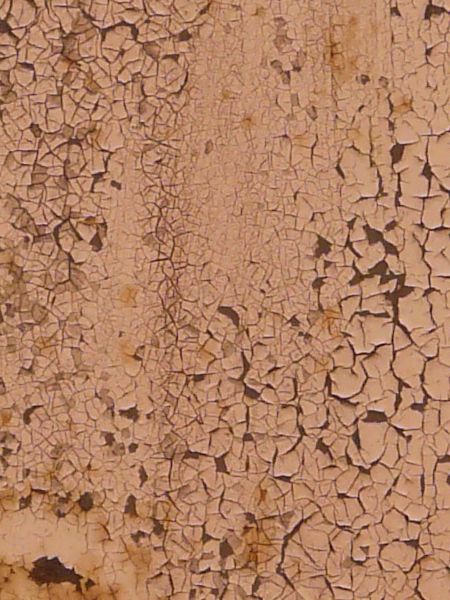 Pink painted metal texture, covered with many small cracks and discolorations, and with a dark red rusted surface visible underneath.