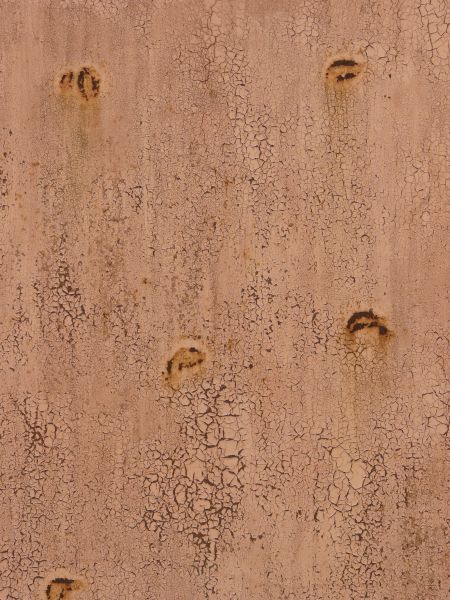 Pink painted metal texture, covered with many small cracks and discolorations, and with a dark red rusted surface visible underneath.