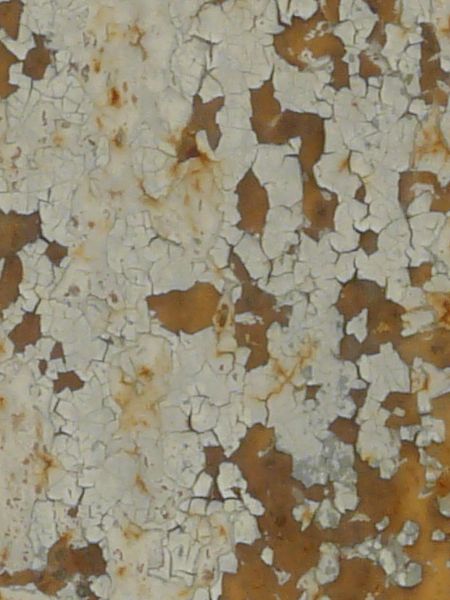 Chipping white paint texture, with yellowish rust spots of various sizes visible throughout.