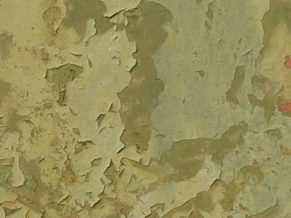 Green painted metal texture, with large chipping areas and brown, light rust stains.