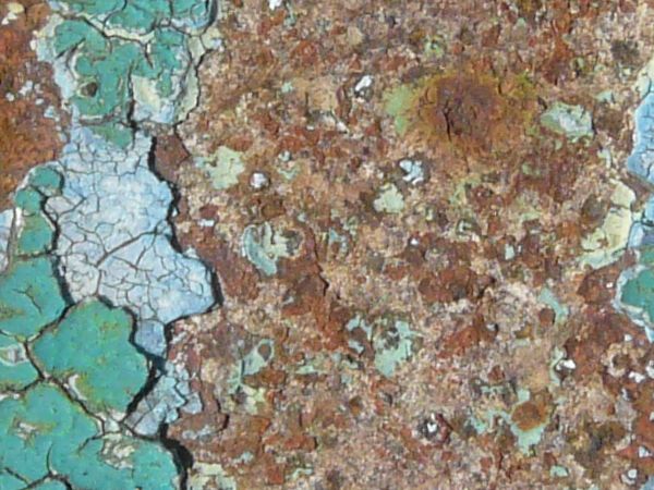 Green painted metal texture, with a rough, rusted surface beneath the chipping paint.