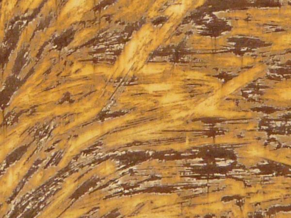 Yellow and brown rust texture, formed in a swirling pattern on three panels of white painted metal.