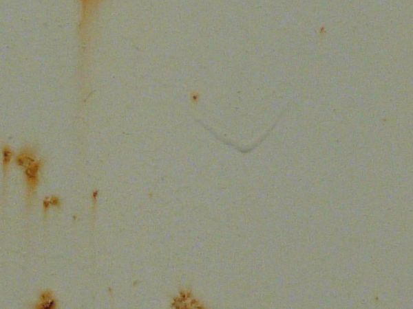 Orange rust marks texture, scattered over a surface of white metal. Large stains and completely rusted patches are also visible.