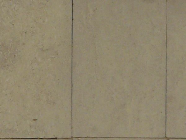 Rectangular tiles in beige tone with rough texture and few chipped edges.