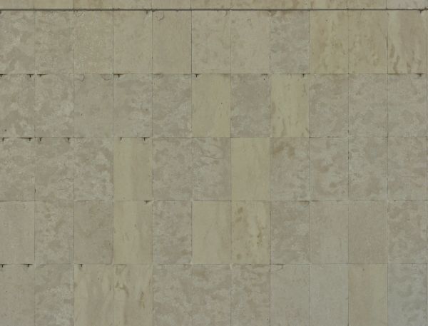Rectangular tiles in beige tone with rough texture and few chipped edges.