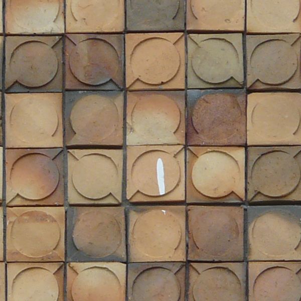 Even, seamless texture of square tiles in various colors with circular shapes on surfaces.