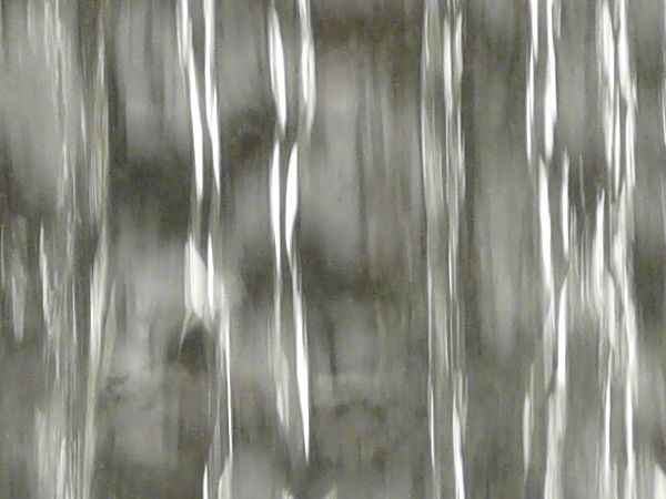 Smooth waterfall texture with shiny, reflecting surface.