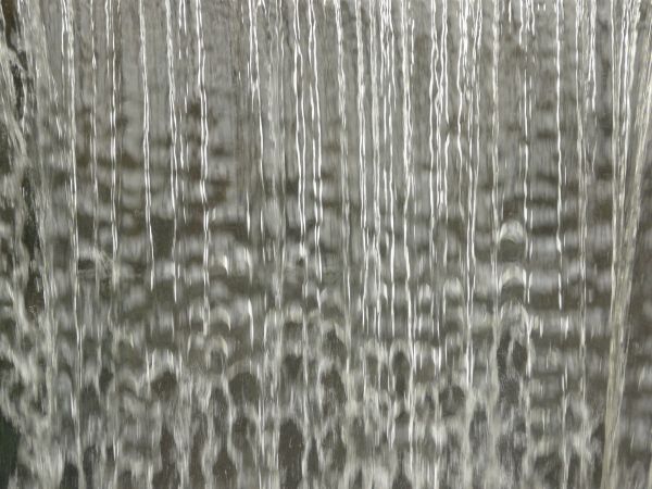 Smooth waterfall texture with shiny, reflecting surface.