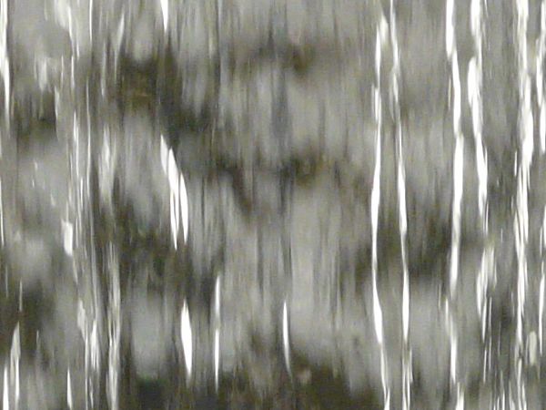 Smooth waterfall texture with shiny, reflecting surface.