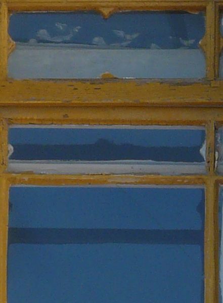 Arched window texture, with various tracery and moldings in the stone and gold painted wood separating the window panes.