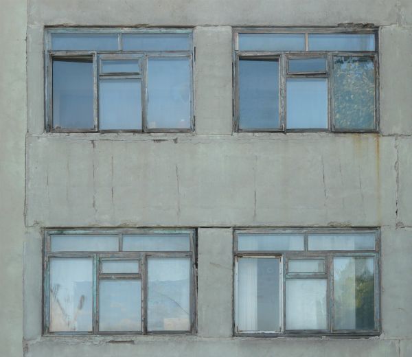 Window texture featuring four separate windows, each divided into six smaller sections by thin frames. The windows are set within a white stone wall with some cracks and stains.